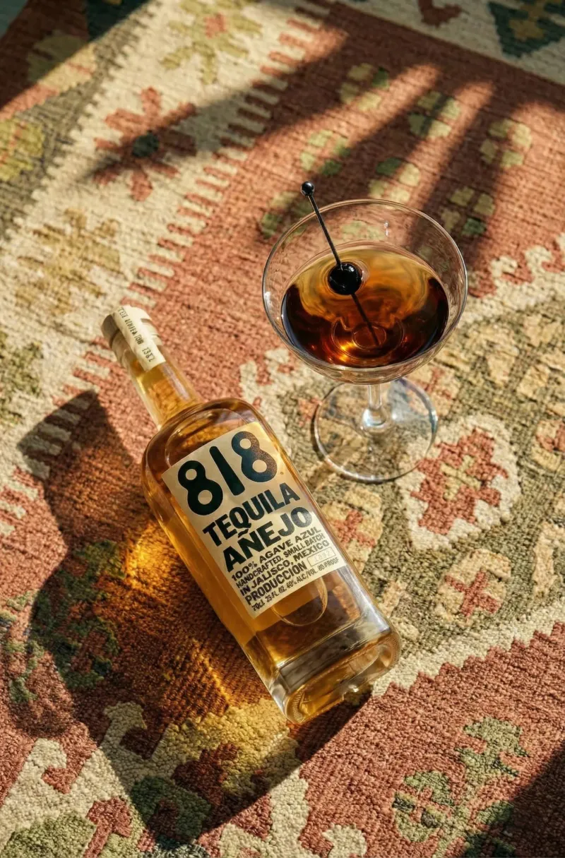 818 Tequila Anejo hero bottle, spirits photography with warm lighting