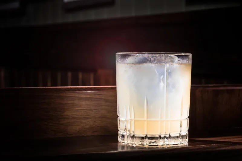 Cloudy citrus serve over a single large ice cube in a cut glass tumbler, Dead Rabbit bar