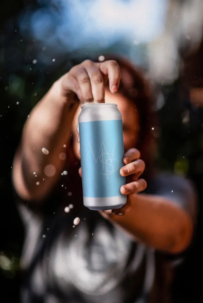 Hand holding a WSP craft beer can outdoors with water droplets and backlight, beer lifestyle photography