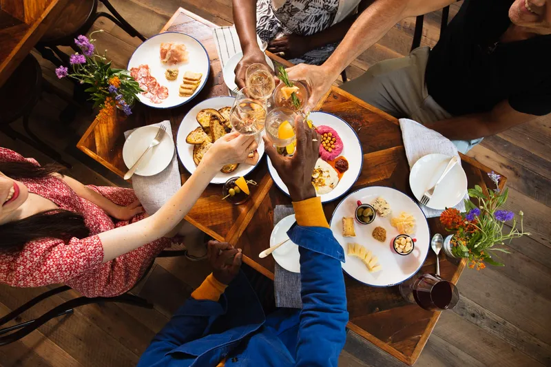 Drinks and food on a Musette restaurant table, hospitality lifestyle