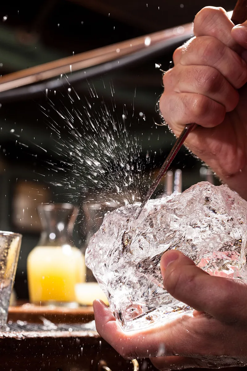Mixologist building a cocktail behind the bar, hospitality lifestyle