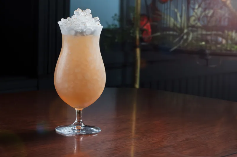Spirits bottle beside a finished cocktail, advertising campaign frame